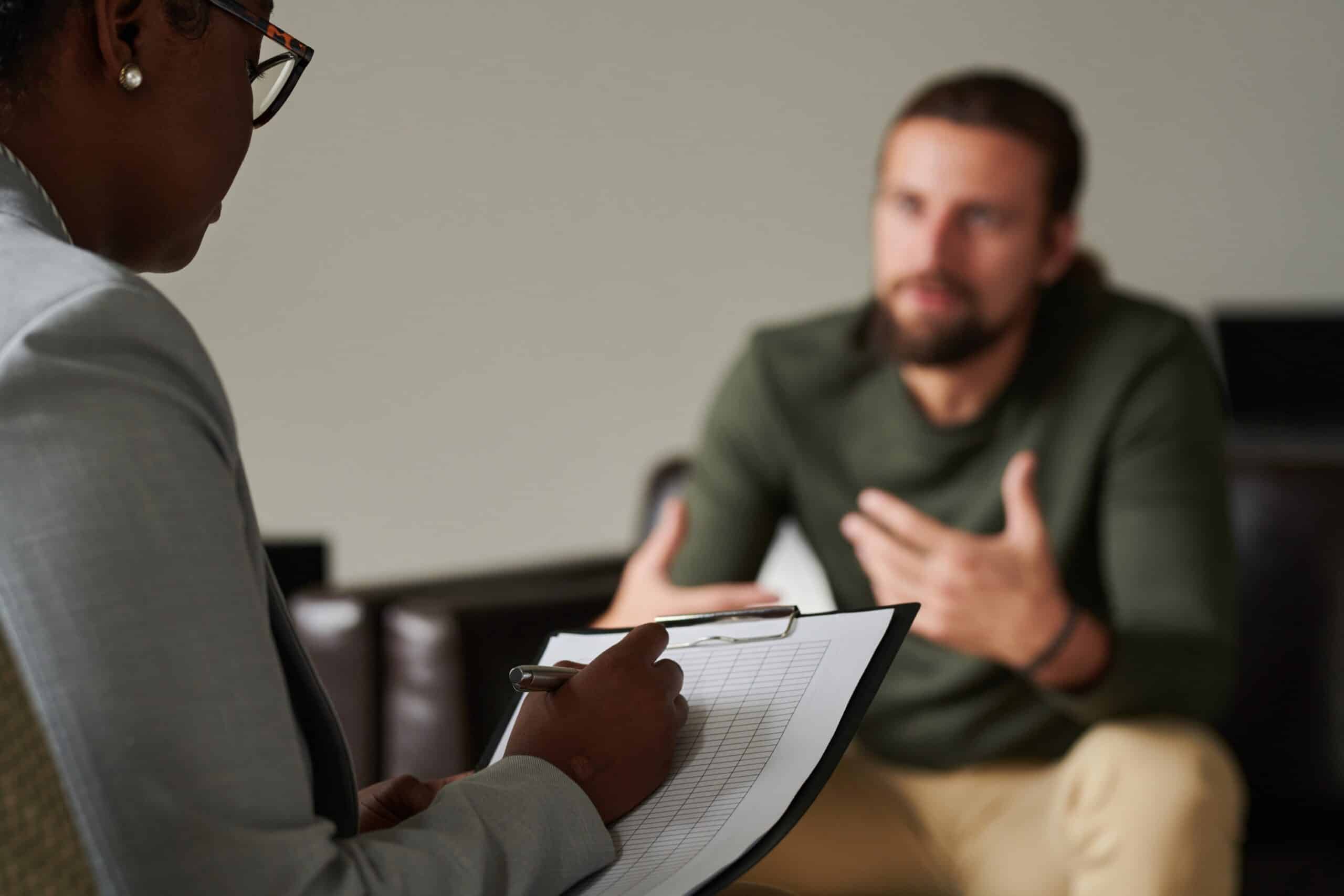Dialectical Behaviour Therapy - Blurred image of a man talking to a therapist