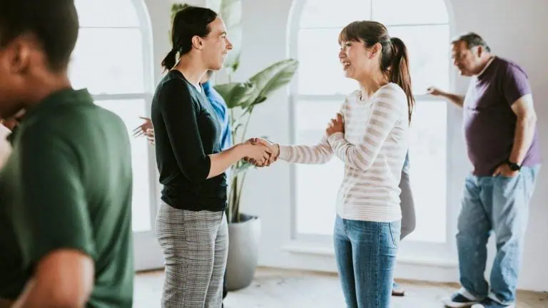 Diverse group of people talking to each other in a supporting group session