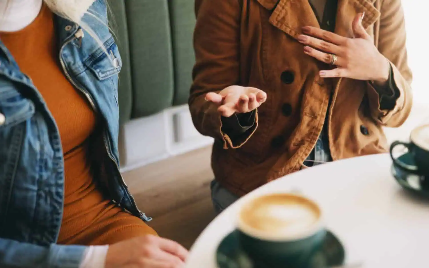 Hands, women and talking at cafe with coffee, concept of support through recovery