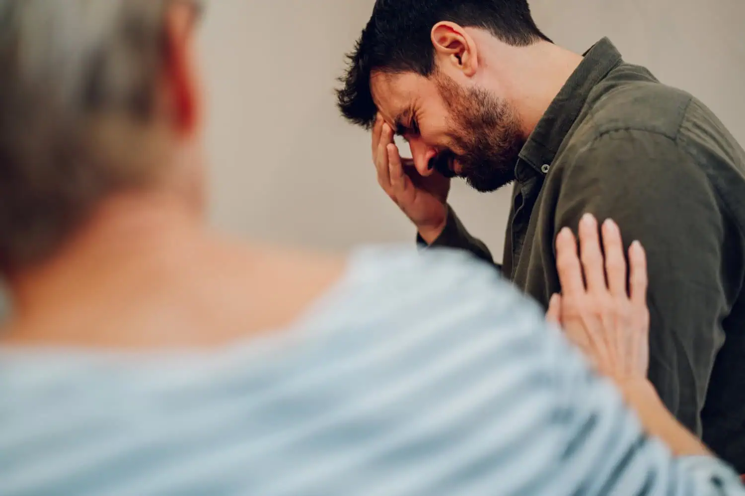 Man Experiencing Grief with Comforting Support
