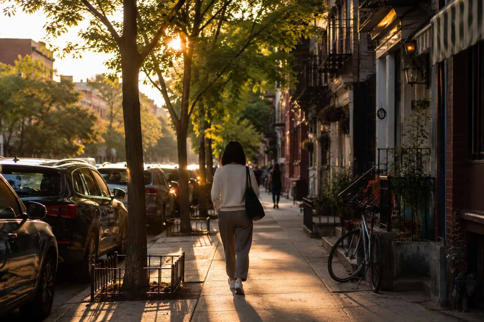 woman walking home alone after work along an ordinary residential street