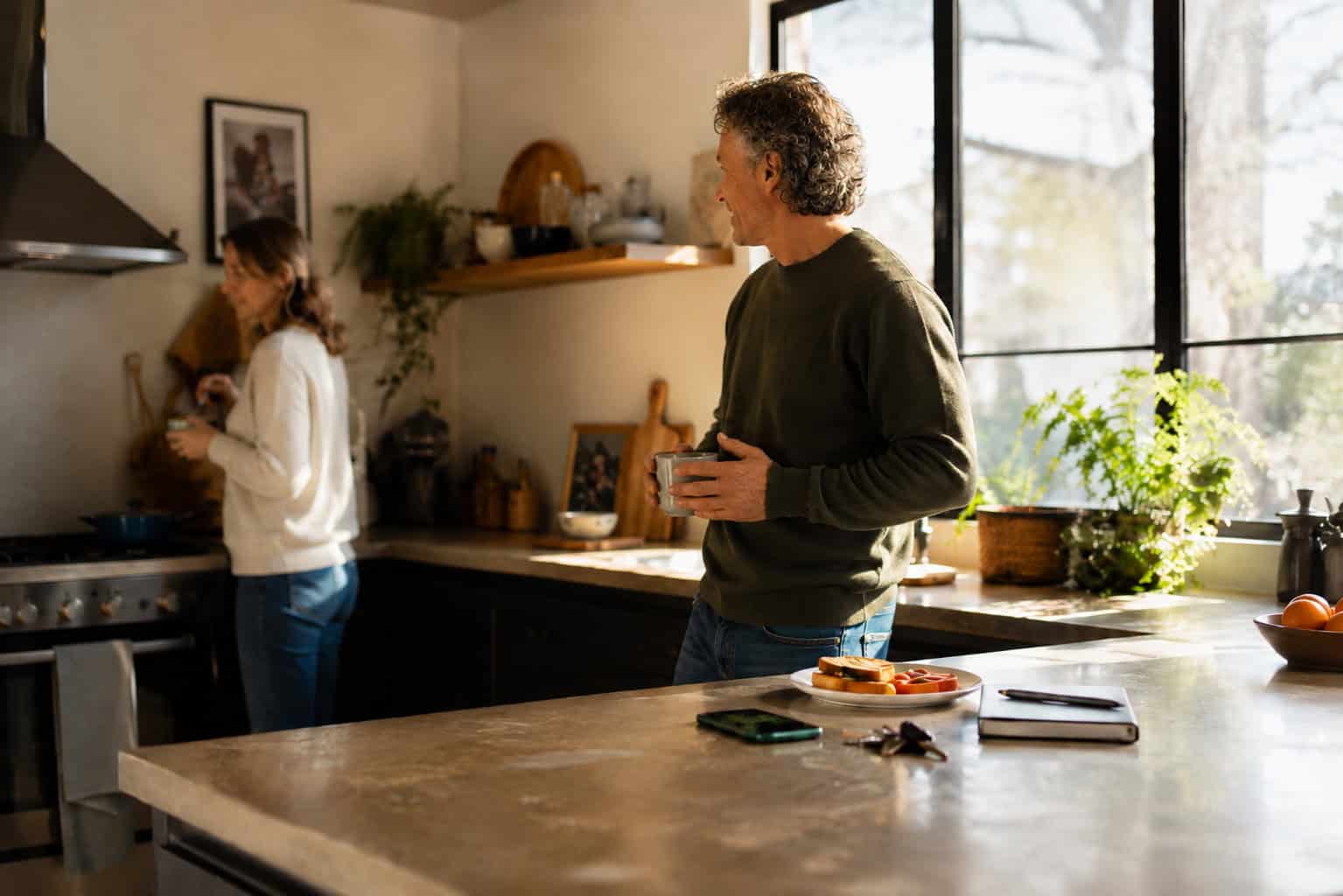 image of a husband and wife happily talking to each other at home, concept of connection and family relationships