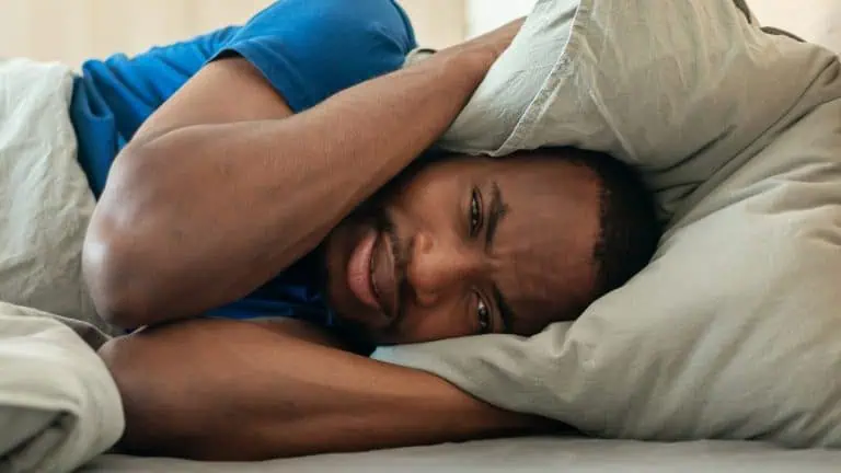 adult man looking exhausted from lack of sleep, concept of insomnia or sleeping problems