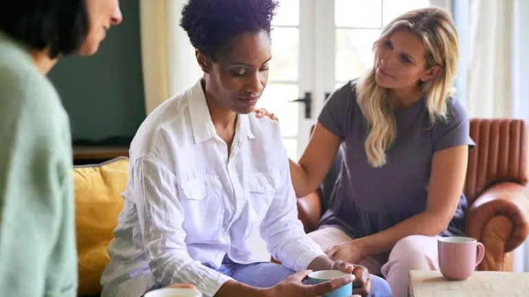 female friends talking and consoling a friend struggling with depression, mental health