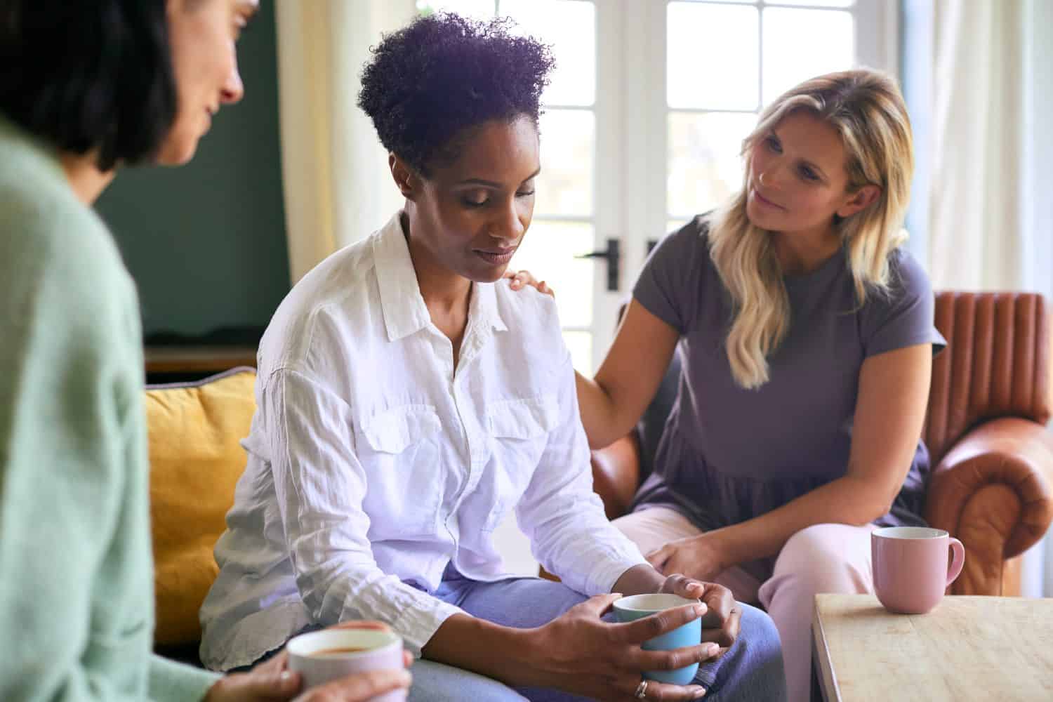 female friends talking and consoling a friend struggling with depression, mental health