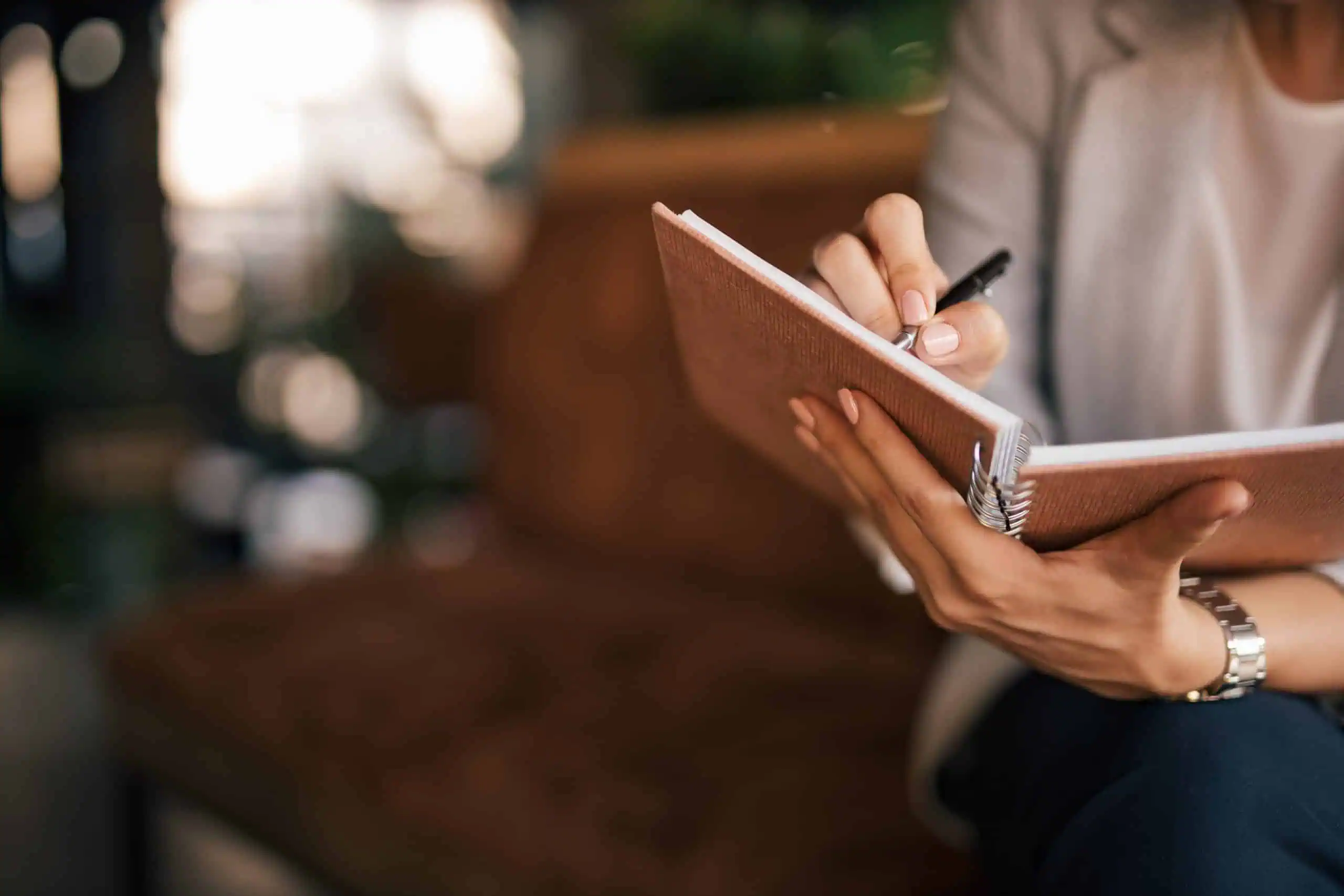 image of blurred background, focus on notes taking or journaling