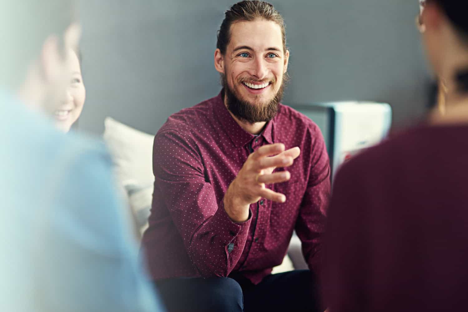 man happily sharing thoughts and ideas during group therapy session, concept of addiction recovery