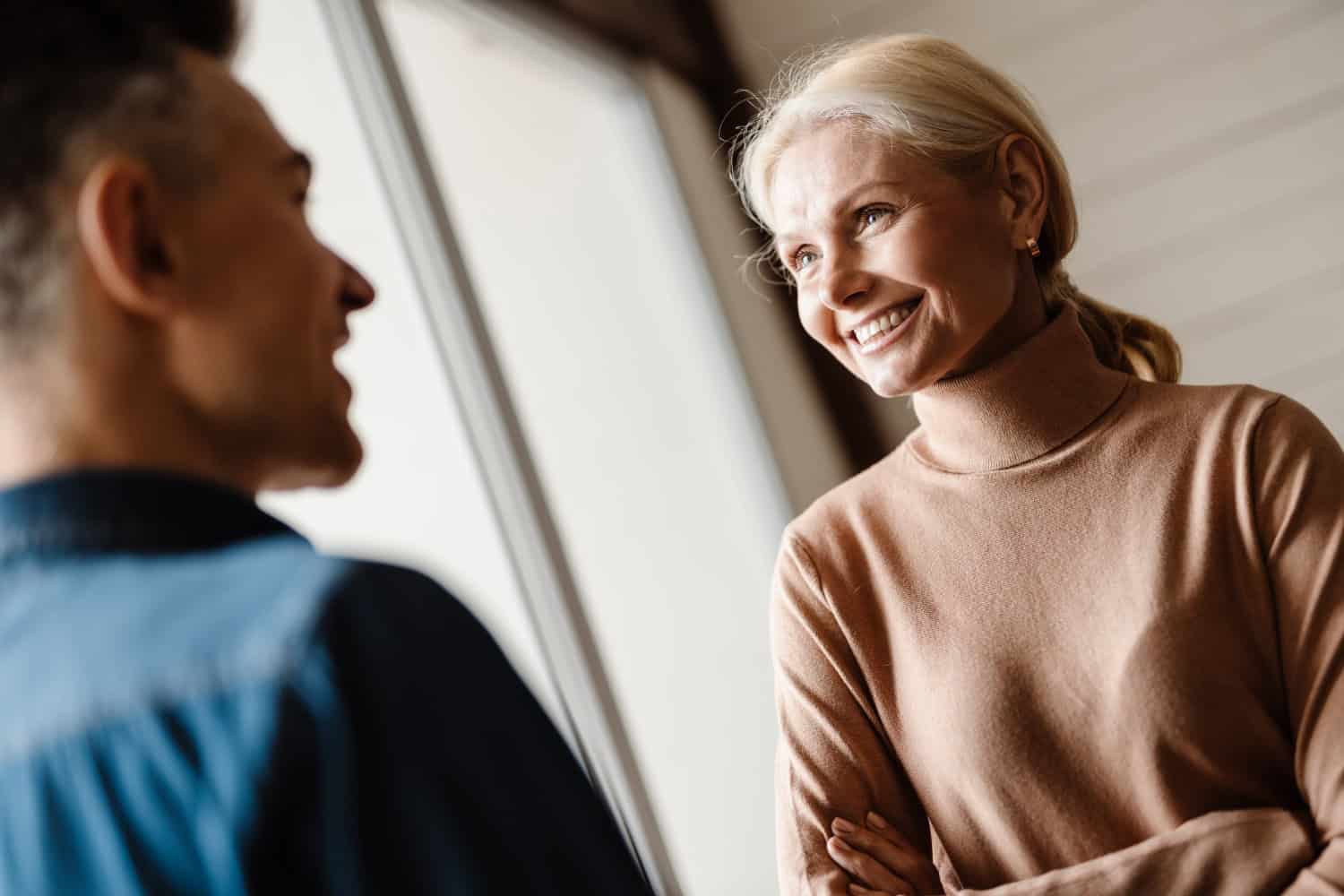 senior woman talking to adult son, concept of family conversation