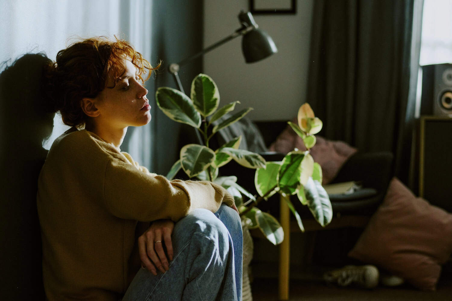 woman leaning on a wall, deep thinking about life