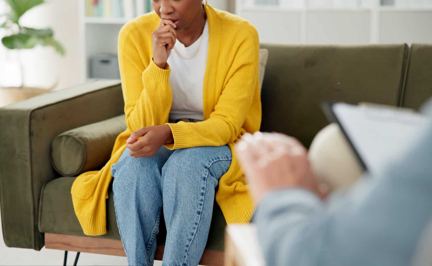 woman with depression sitting on sofa for counseling in anxiety, trauma or stress