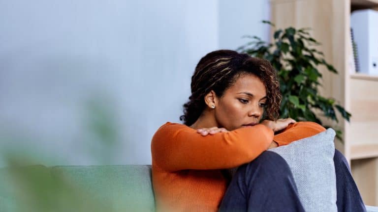young businesswoman looking stressed out, depressed, alone in an office