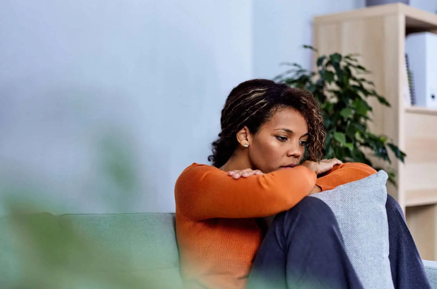 young businesswoman looking stressed out, depressed, alone in an office